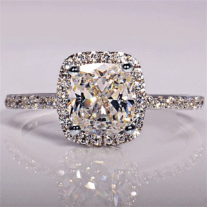 Cushion cut halo engagement ring with diamond pave band